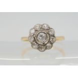 A DIAMOND FLOWER RING the bright yellow metal mount is set with estimated approx 0.40cts, of old cut
