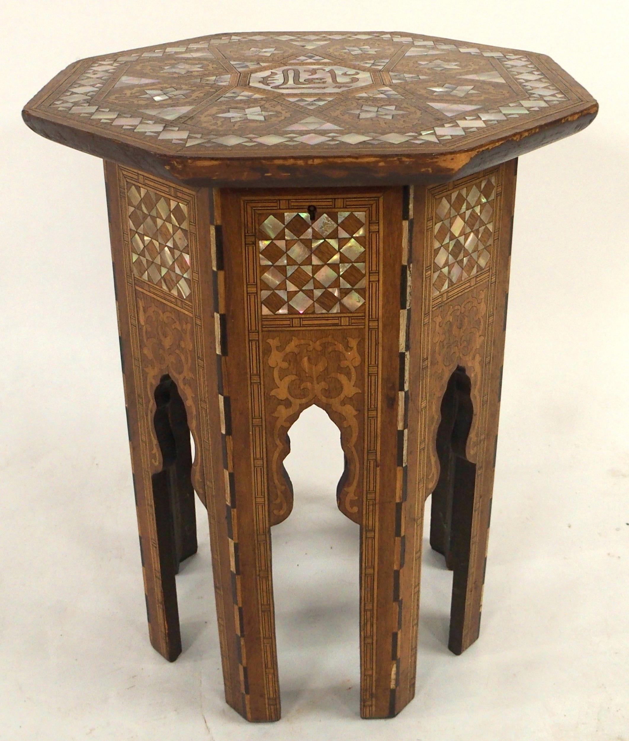 AN EARLY 20TH CENTURY MOORISH STYLE SEWING TABLE IN THE MANNER OF LIBERTY OF LONDON with octagonal