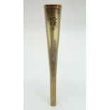 A LONDON 2012 OLYMPIC BEARER'S TORCH Of tapering, triangular form, gold coloured, bearing the