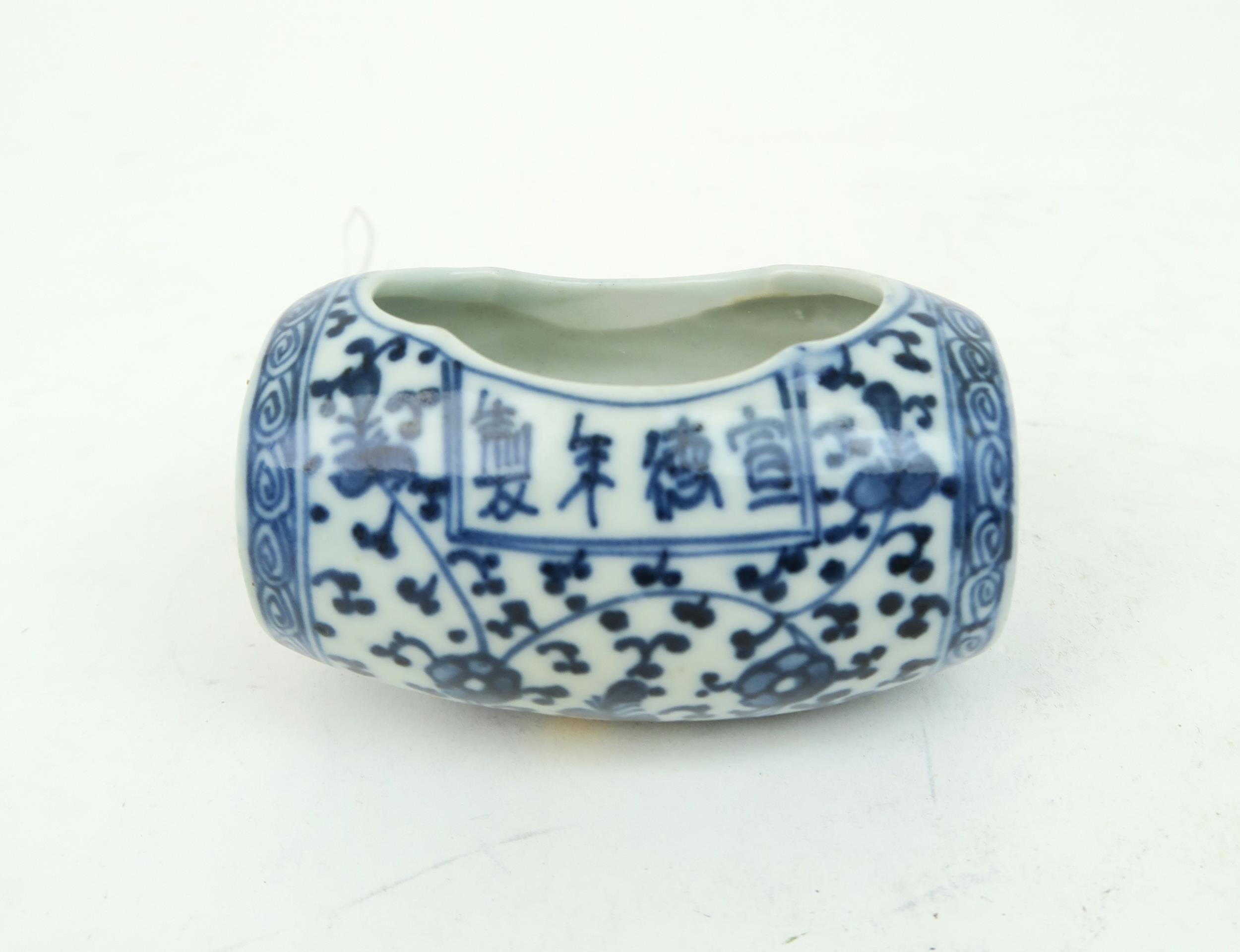 A CHINESE BLUE AND WHITE BARREL BIRD FEEDER  Painted with meandering foliage, joined with two