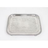A GEORGE III SILVER WAITER of rectangular form, with a gadrooned rim, the centre engraved with