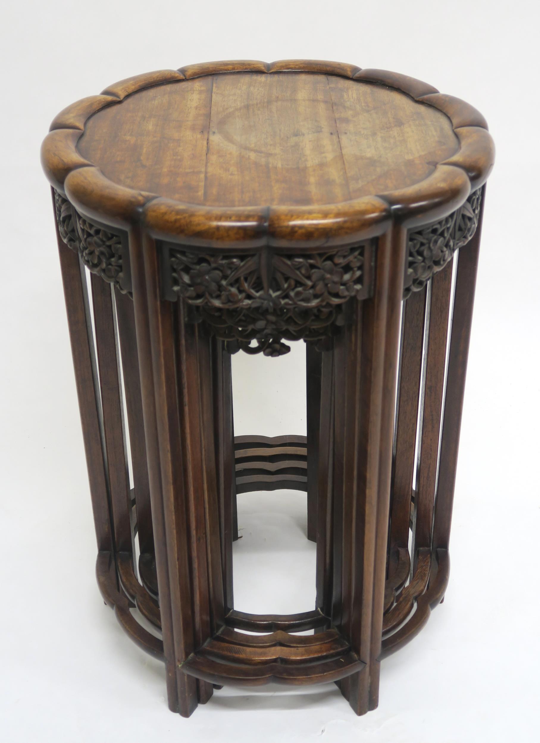 A 19TH CENTURY CHINESE HARDWOOD CIRCULAR NEST OF FOUR TABLES with shaped circular tops over carved