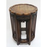 A 19TH CENTURY CHINESE HARDWOOD CIRCULAR NEST OF FOUR TABLES with shaped circular tops over carved