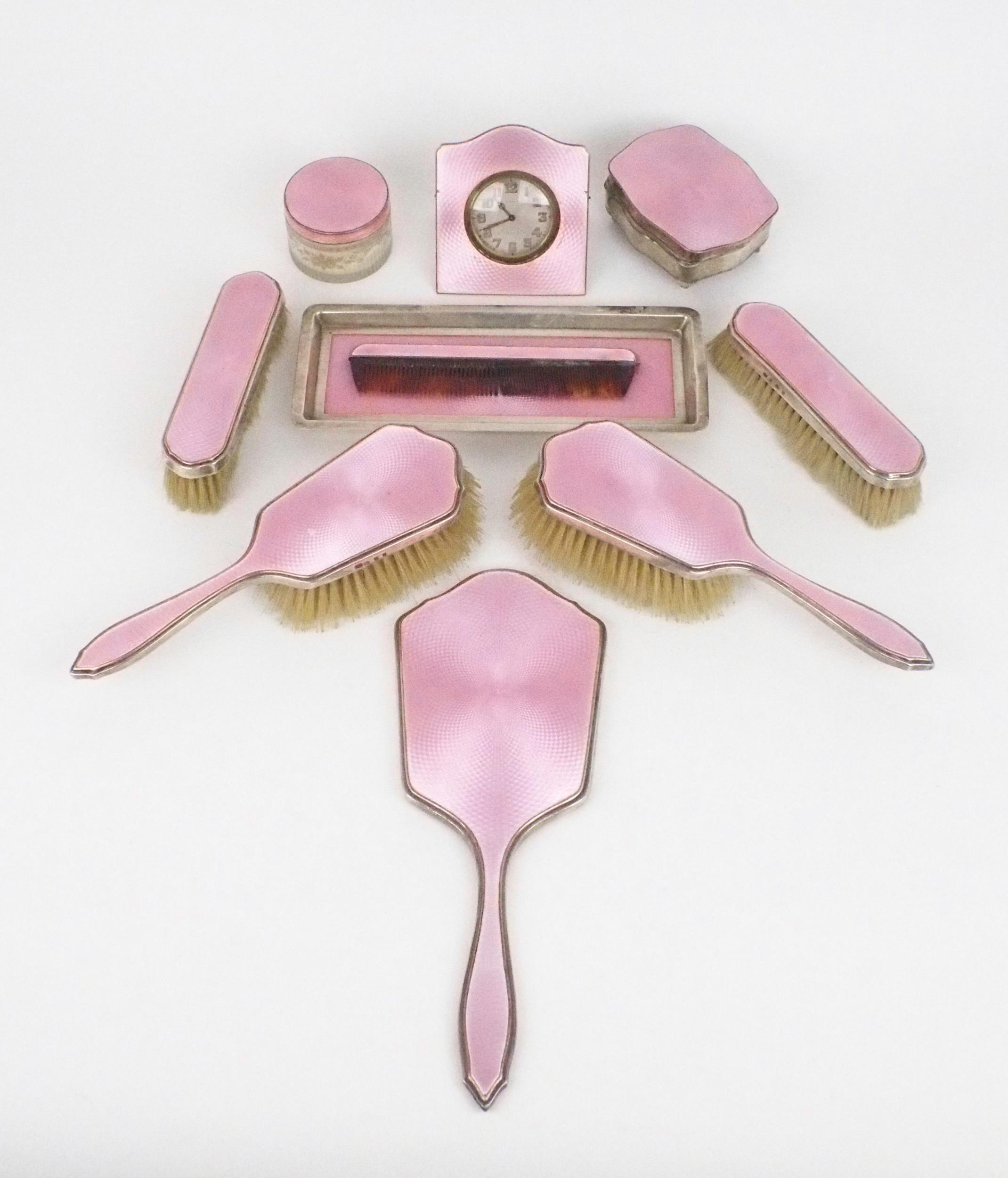 A GEORGE V TEN PIECE SILVER AND GUILLOCHE ENAMEL DRESSING SET comprising two clothes brushes, two