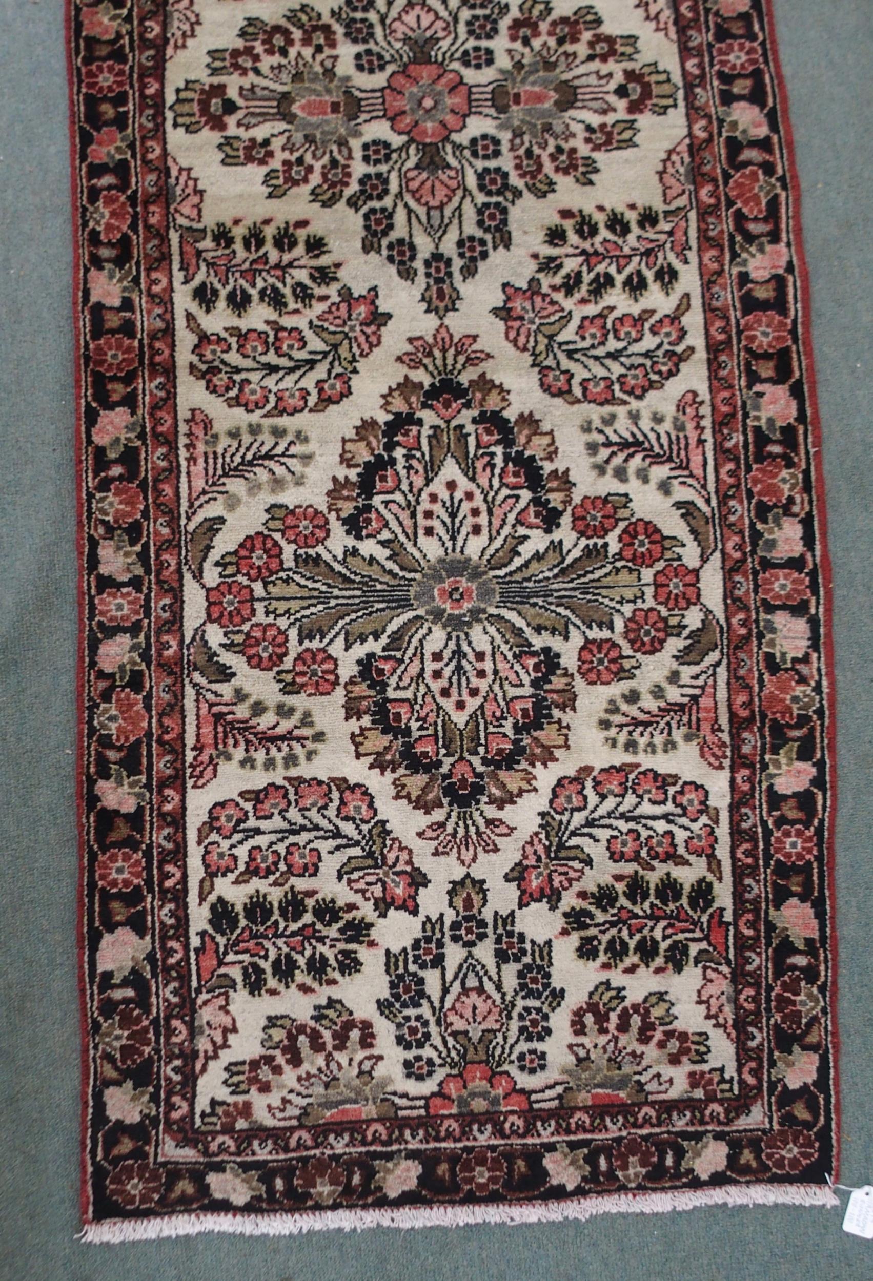 A CREAM GROUND HAMADAN RUNNER with seven floral medallions and dark blue floral border, 459cm long x - Image 2 of 6