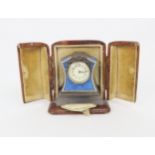 A FRENCH SILVER AND BLUE BASSE-TAILLE ENAMEL MINIATURE TIMEPIECE upon a carved agate base, with