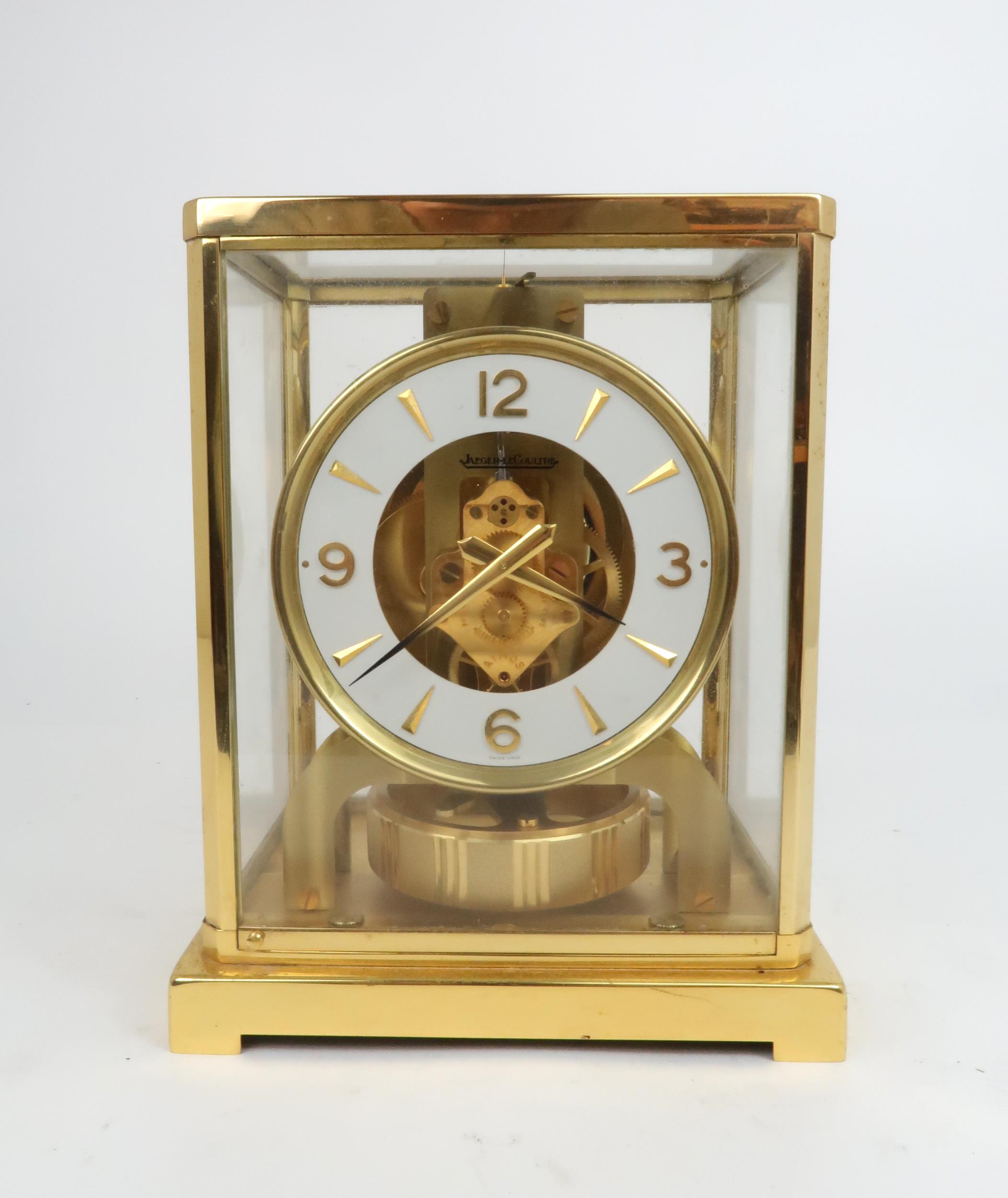 A JAEGER LE COULTRE ATMOS CLOCK in glazed brass case, the white enamel chapter ring with applied