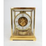 A JAEGER LE COULTRE ATMOS CLOCK in glazed brass case, the white enamel chapter ring with applied