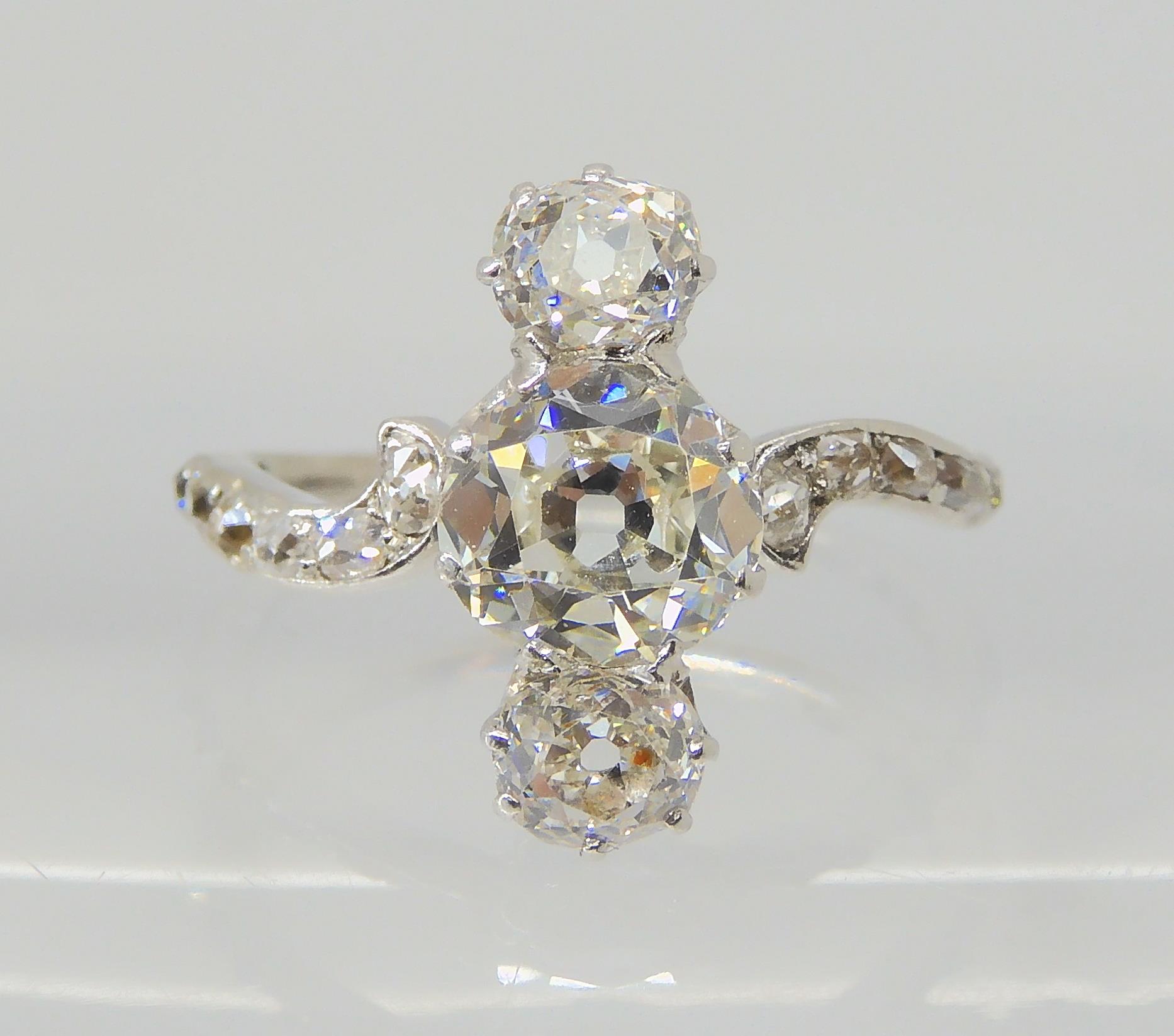 A VINTAGE THREE STONE DIAMOND RING the central old cut is estimated approximately at 0.95cts, with - Image 3 of 12