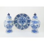 A LARGE DELFT DISH decorated with a basket of flowers, 34.5cm diameter, together with a pair of