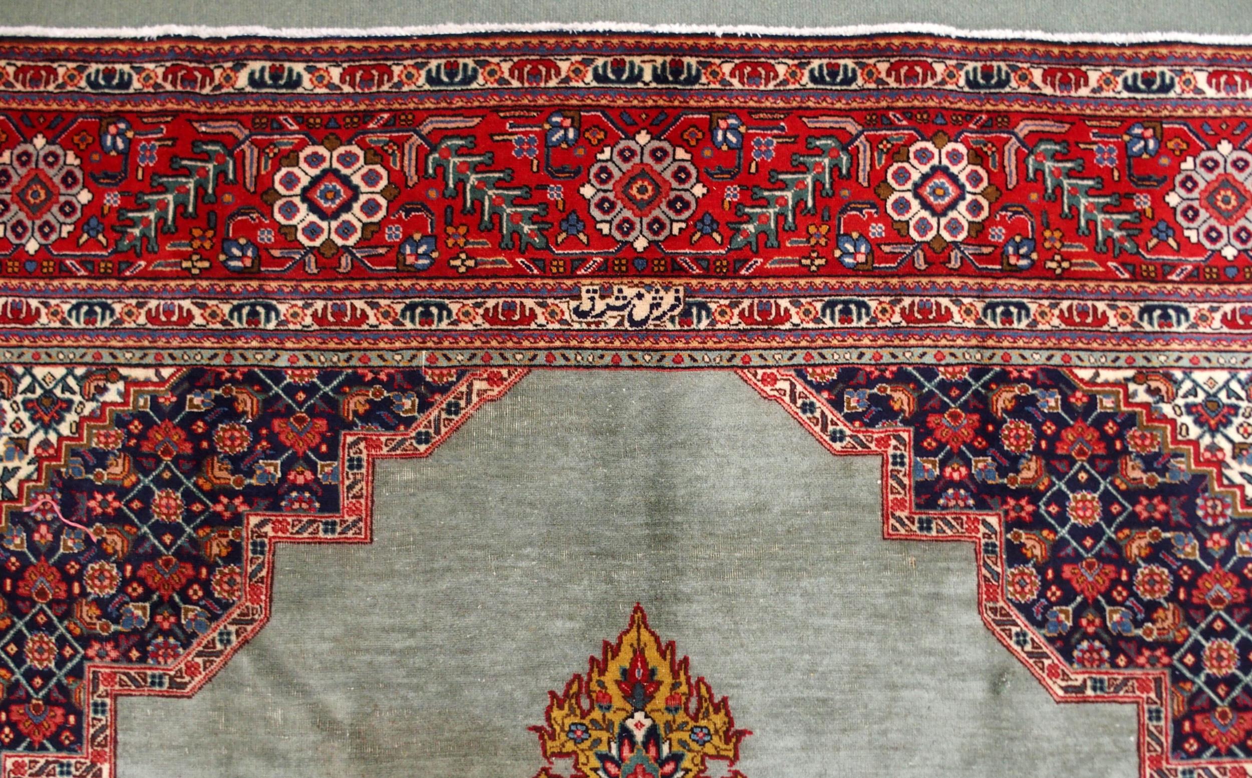 A GREEN GROUND TABRIZ RUG with red geometric central medallion, dark blue and white spandrels and - Image 7 of 7