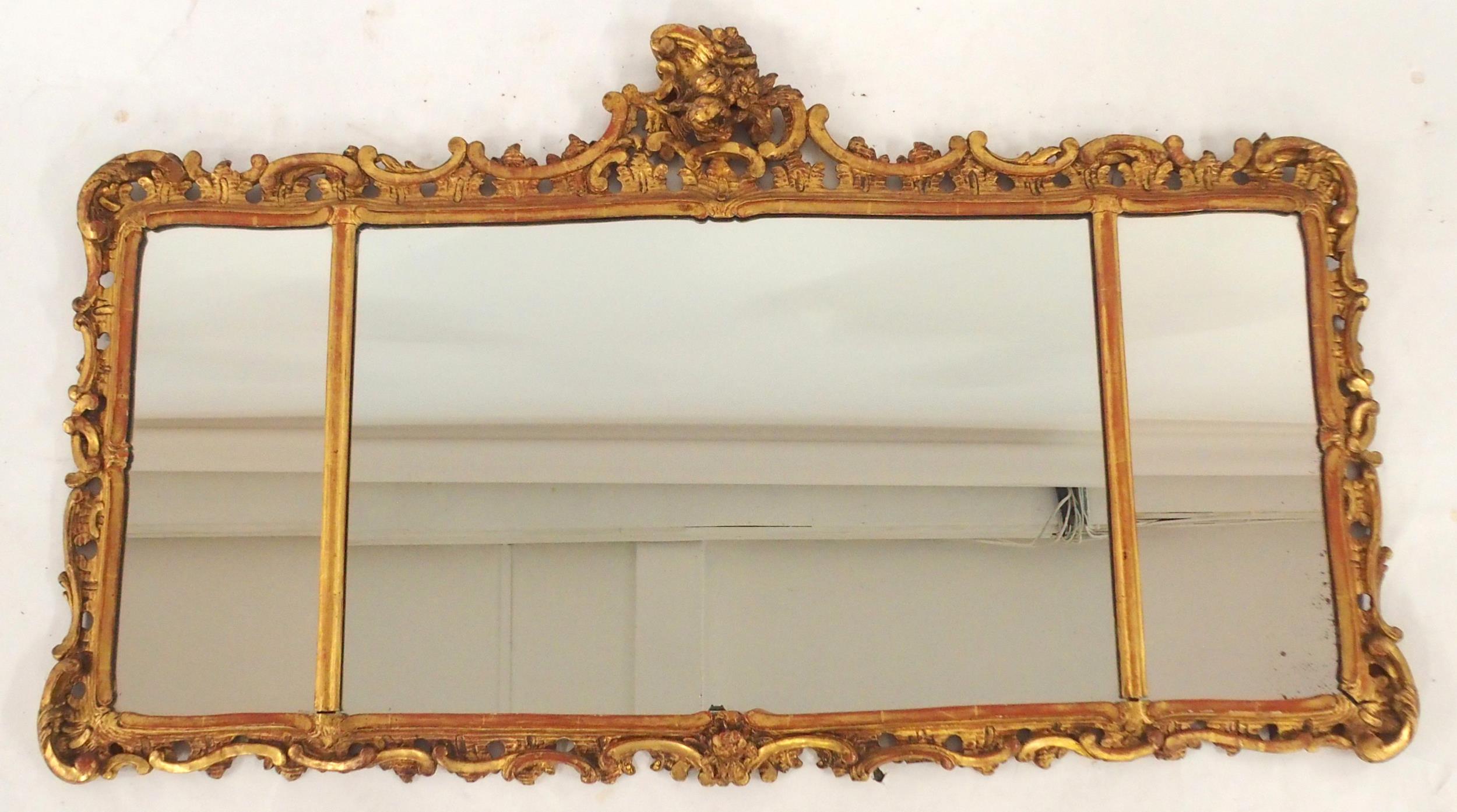 AN 18TH CENTURY STYLE GILTWOOD ROCOCO STYLE TRIPLE PLATE WALL MIRROR with floral surmount over