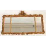 AN 18TH CENTURY STYLE GILTWOOD ROCOCO STYLE TRIPLE PLATE WALL MIRROR with floral surmount over