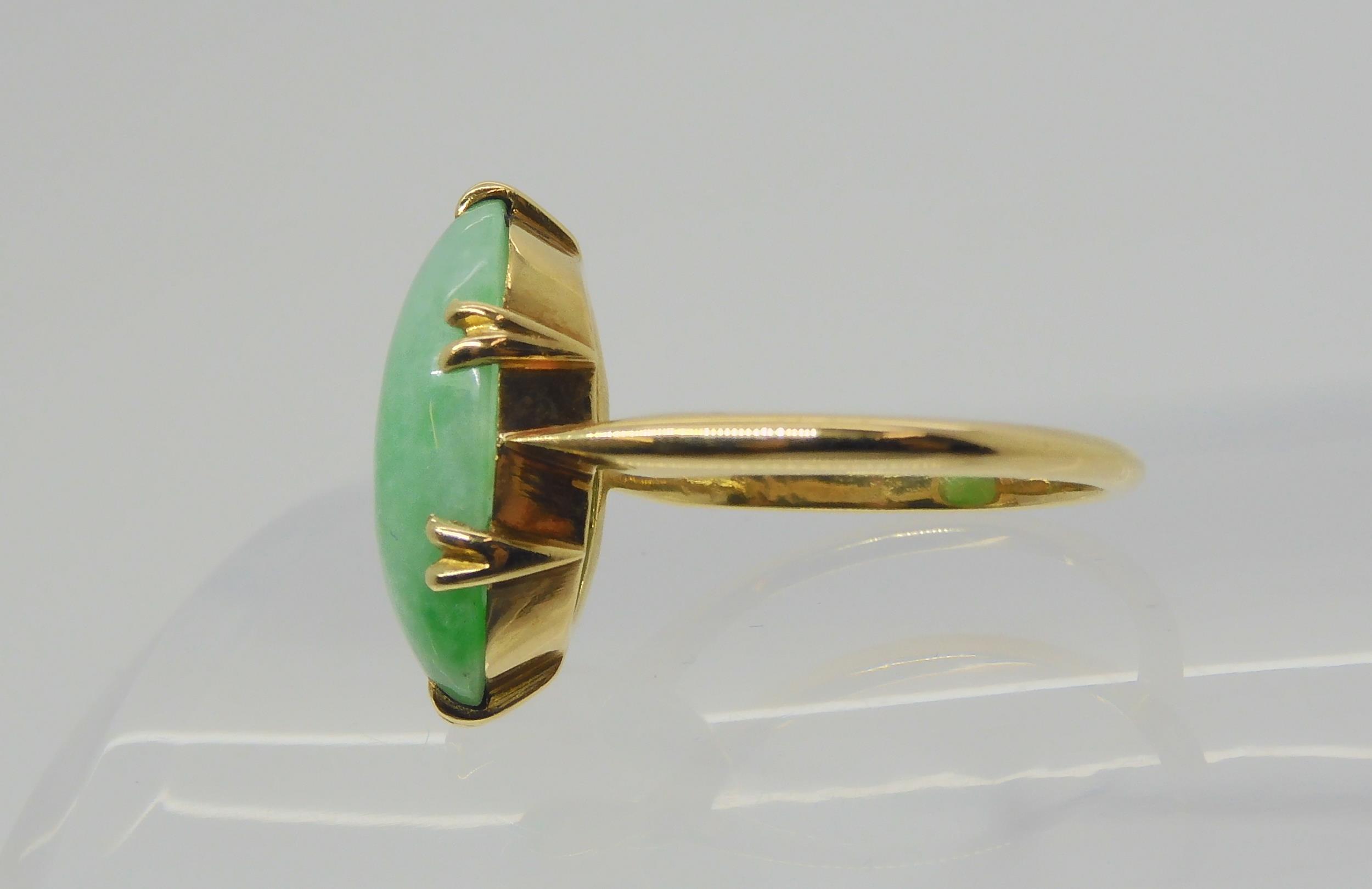 A CHINESE GREEN HARDSTONE RING mounted in bright yellow metal, the hardstone measures approx 16mm - Image 4 of 4