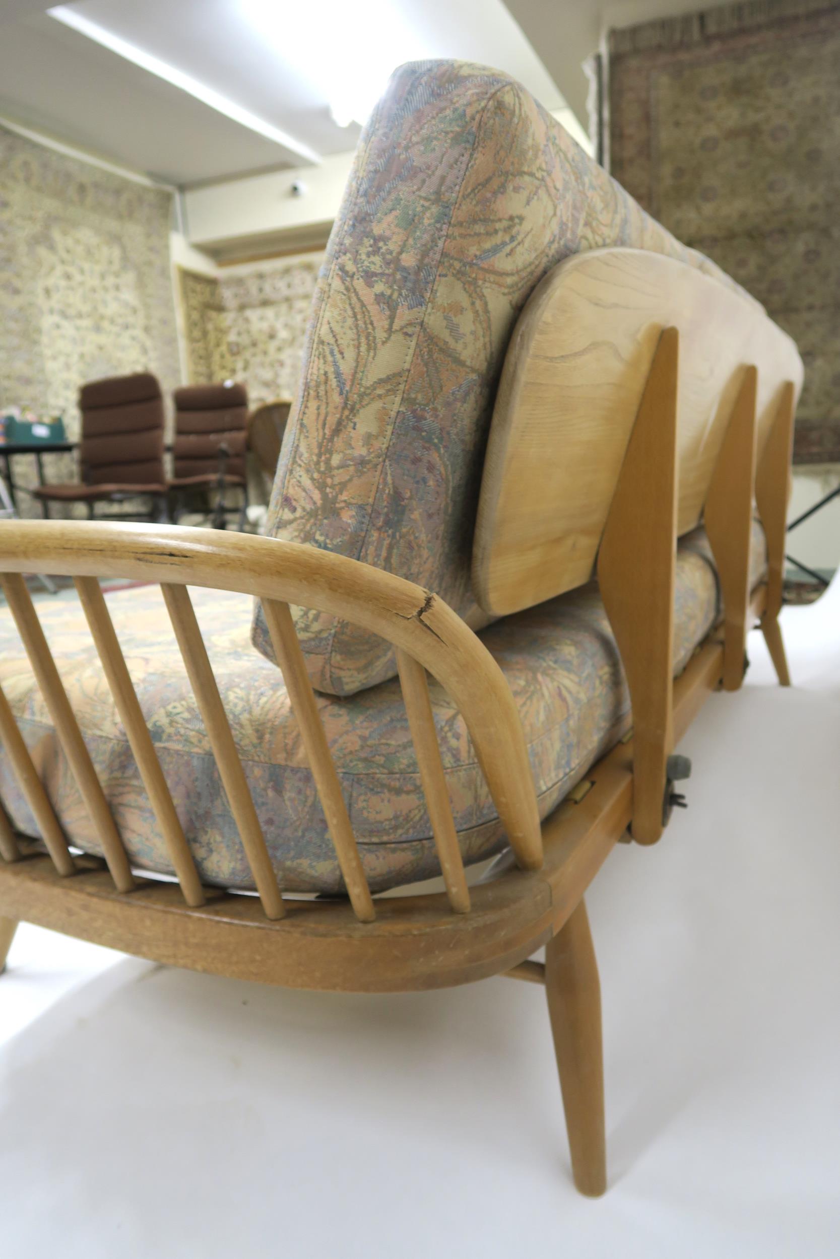 A MID 20TH CENTURY ELM AND BEECH FRAMED ERCOL DAY BED with floral upholstered cushions, 77cm high - Image 6 of 11