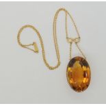 A LARGE CITRINE PENDANT  with infinity symbol and chain links. Dimensions of the citrine 2.9cm x 1.