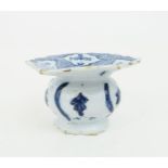 AN 18TH CENTURY DUTCH DELFT SPITTOON with flared scalloped edge, painted with sprigs of flowers,