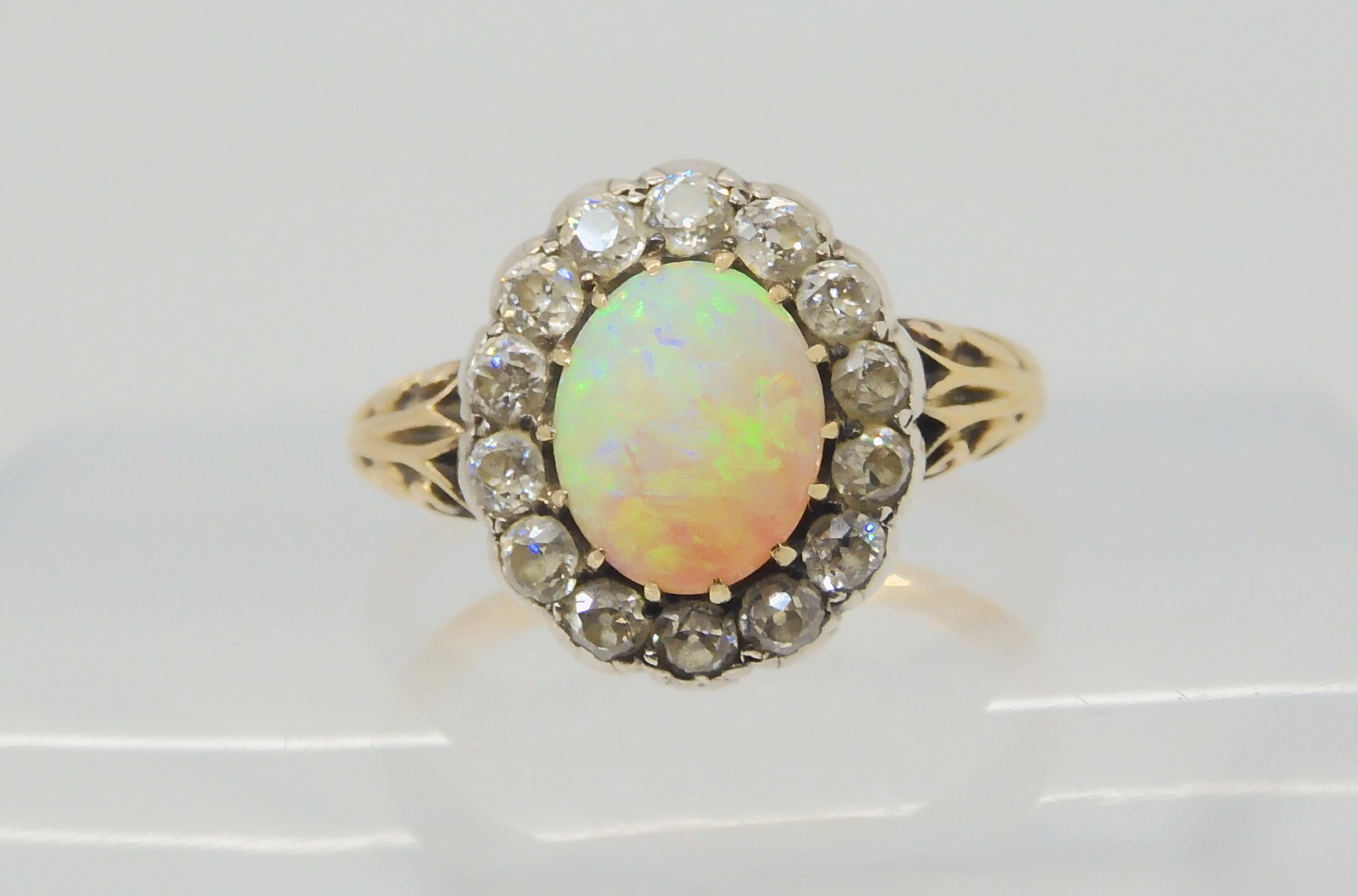 AN OPAL AND DIAMOND RING set with a high domed opal of approx 8.8mm x 7.1mm x 4.1mm, surrounded with - Image 2 of 5