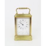 A FRENCH BRASS AND GLASS REPEATING CARRIAGE CLOCK by Drocourt for J. W. Benson, London with striking