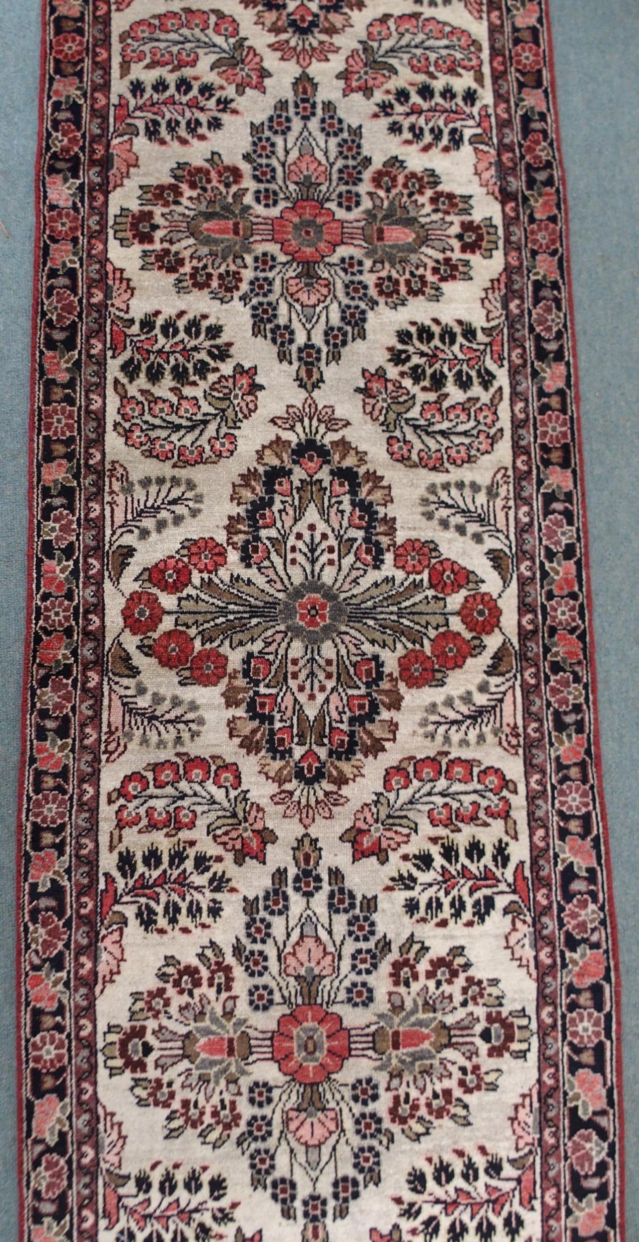 A CREAM GROUND HAMADAN RUNNER with seven floral medallions and dark blue floral border, 459cm long x - Image 4 of 6