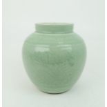 A CHINESE CELADON VASE  Carved with an archaic band above scrolling foliage, and horizontal banding,