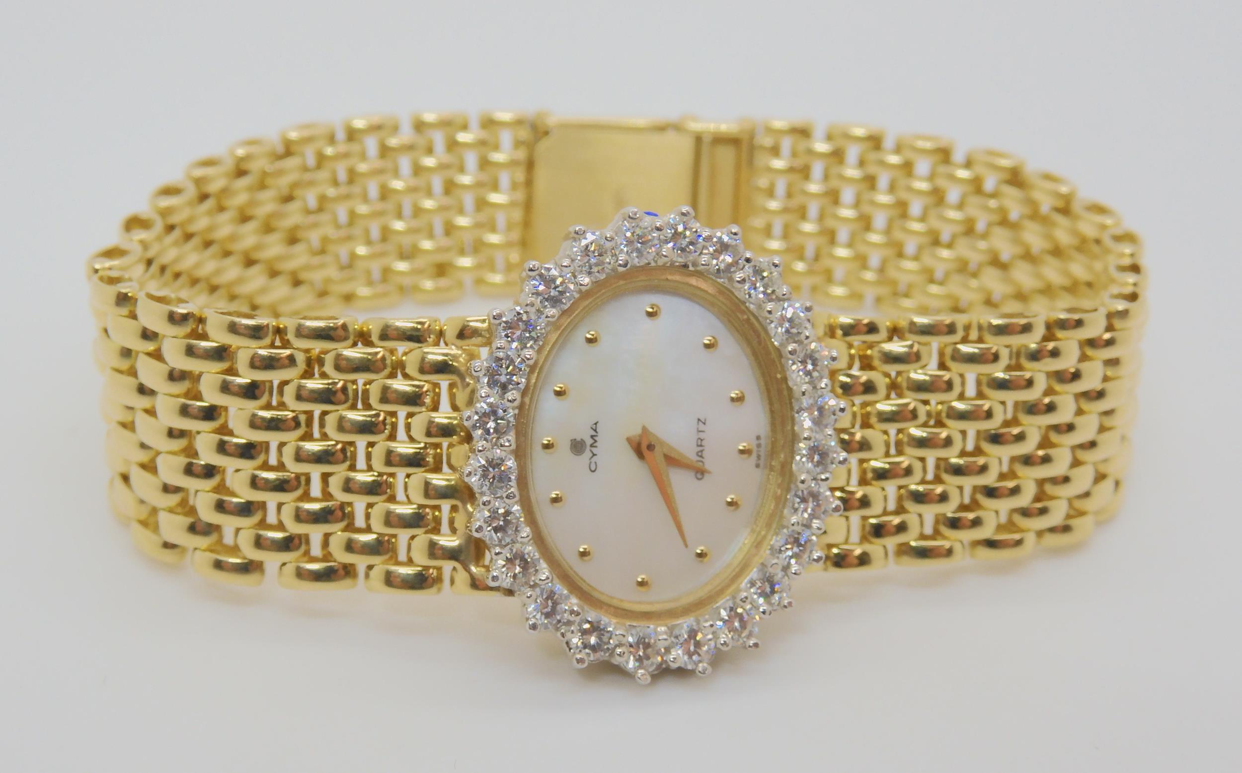 A 14K GOLD DIAMOND SET CYMA LADIES WATCH mother of pearl dial with gold dot numerals, set with