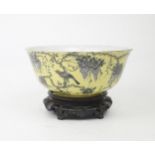 A CHINESE YELLOW GROUND BOWL  Painted with a bird amongst wisteria,within gilt rims red seal and