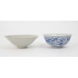 A CHINESE CELADON GLAZED BOWL  Carved with foliage, 19.5cm diameter and a blue and white dragon