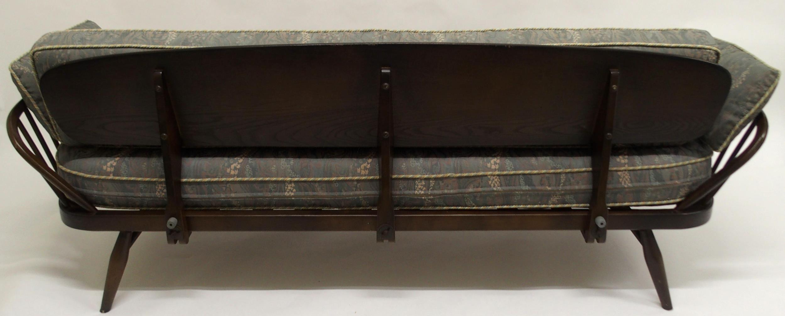 A MID 20TH CENTURY STAINED ELM AND BEECH FRAMED ERCOL DAY BED with blue upholstered cushions, 77cm - Image 7 of 9