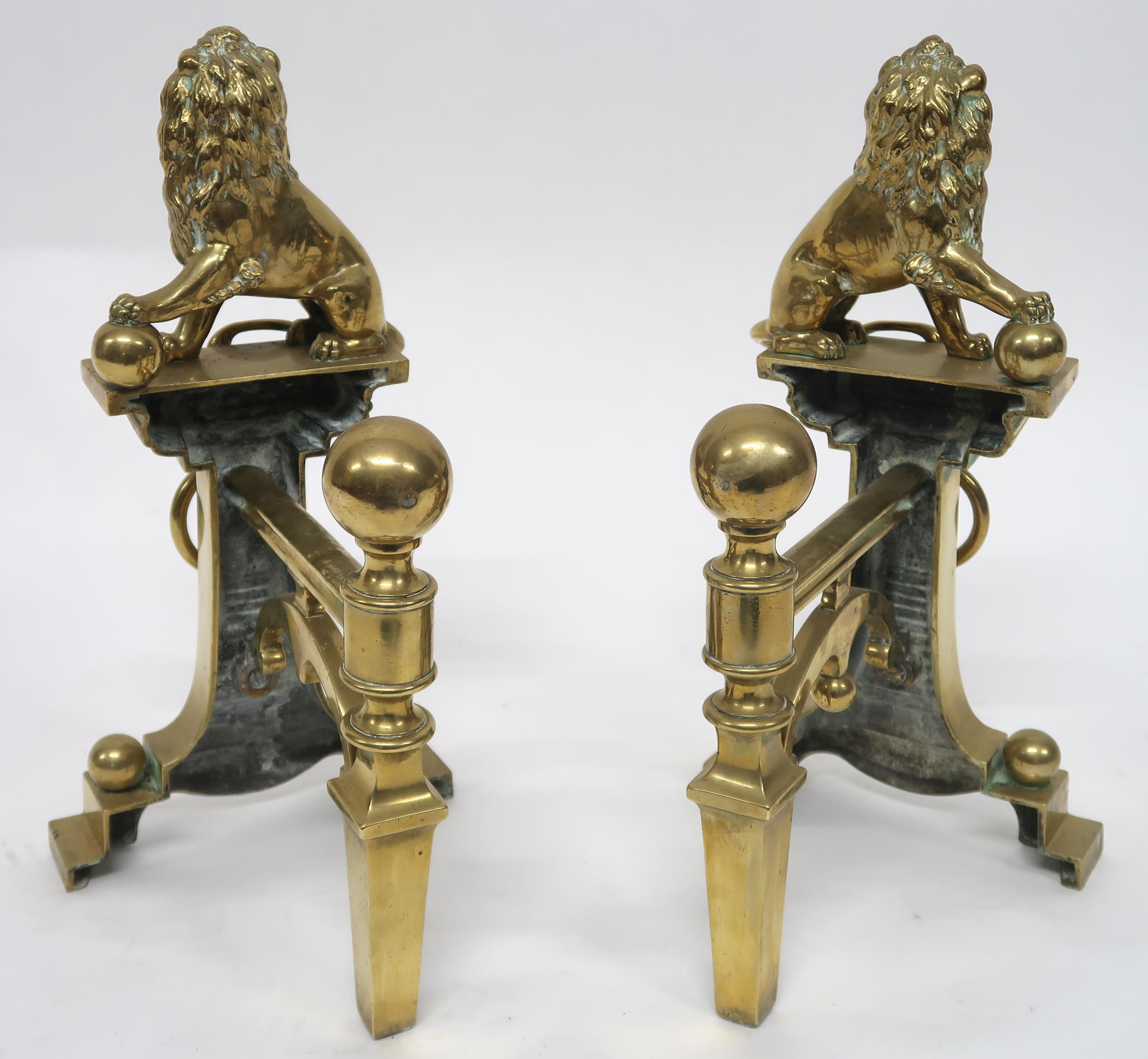 A PAIR OF EARLY 20TH CENTURY CAST BRASS FIRE DOGS mounted with figural lions, 46cm high x 23cm - Image 4 of 7