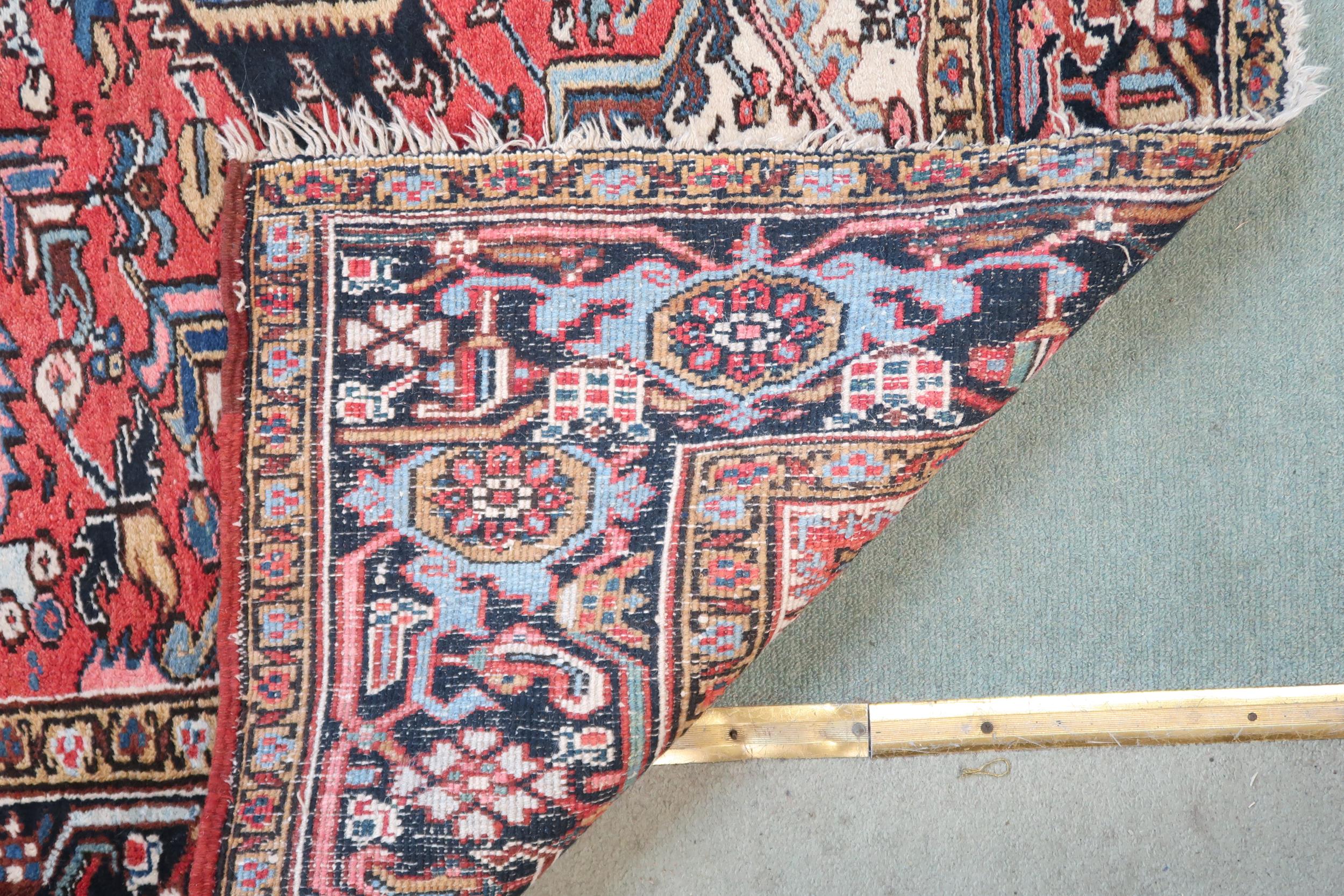 A RED GROUND KAZAK RUG with dark blue geometric central medallion, off white spandrels and geometric - Image 3 of 7