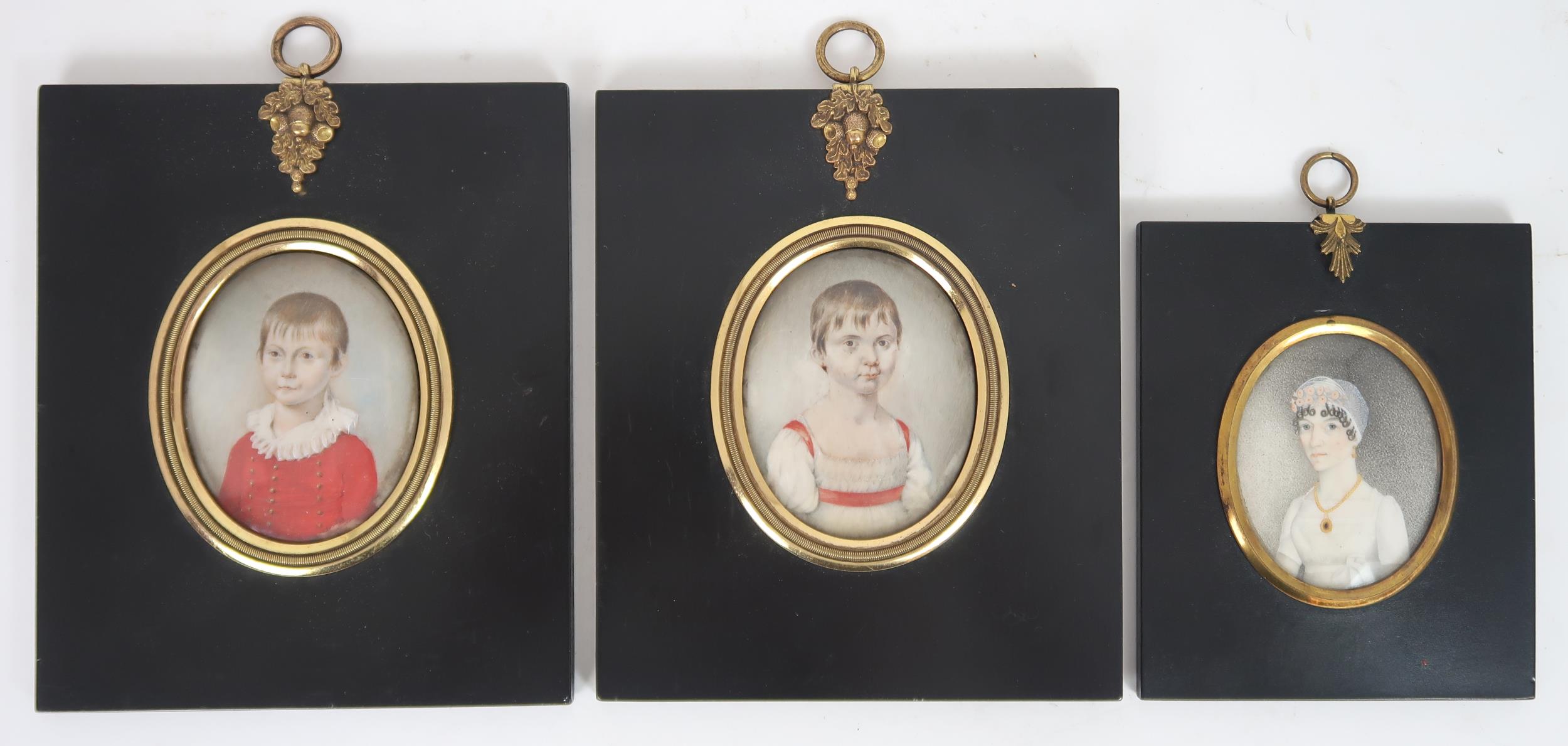 THREE REGENCY PORTRAIT MINIATURES PAINTED ON IVORY In ebonised frames, comprising a lady with