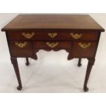 A GEORGIAN MAHOGANY LOWBOY with one long over three short drawers all with brass drawer pulls over