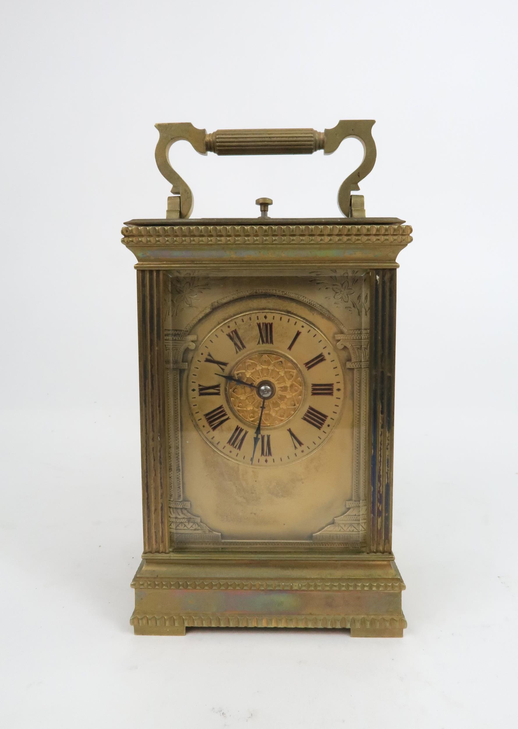 A FRENCH BRASS AND GLASS REPEATING CARRIAGE CLOCK the gilded face with applied column and arch