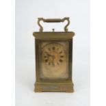 A FRENCH BRASS AND GLASS REPEATING CARRIAGE CLOCK the gilded face with applied column and arch