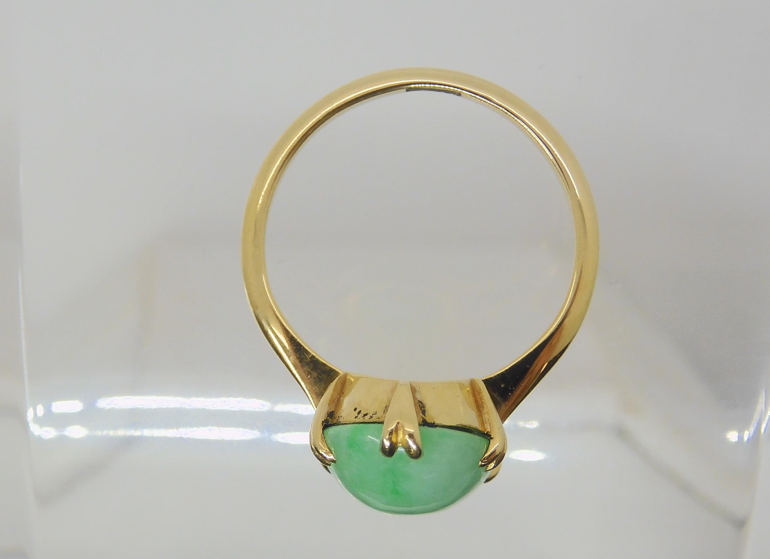 A CHINESE GREEN HARDSTONE RING mounted in bright yellow metal, the hardstone measures approx 16mm - Image 3 of 4