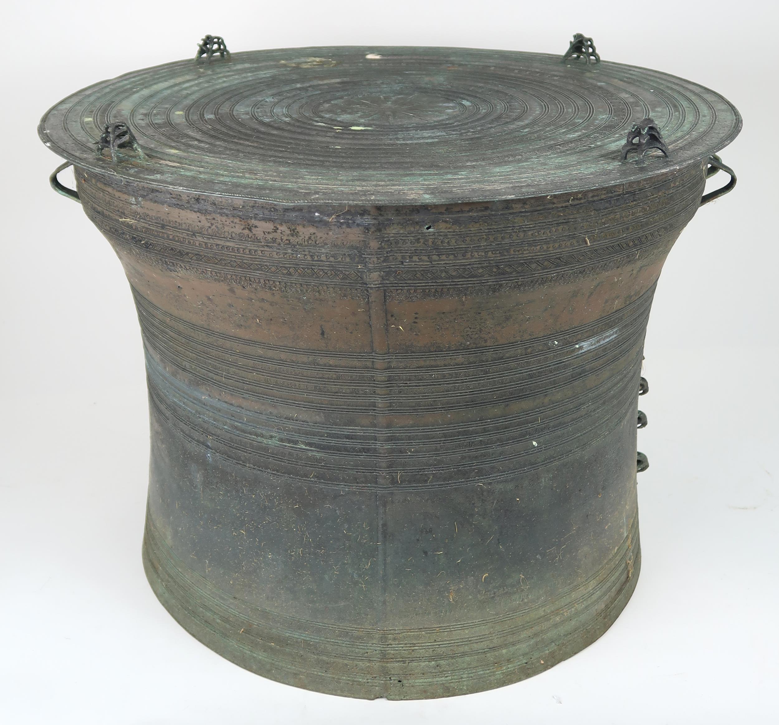 A LAOTIAN BRONZE RAIN DRUM  Of traditional type, with applied animals to top and pierced strap