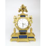 A LEOPOLD SCHMIDT PRAG GILTWOOD CHIMING MANTLE CLOCK the circular white enamel face with