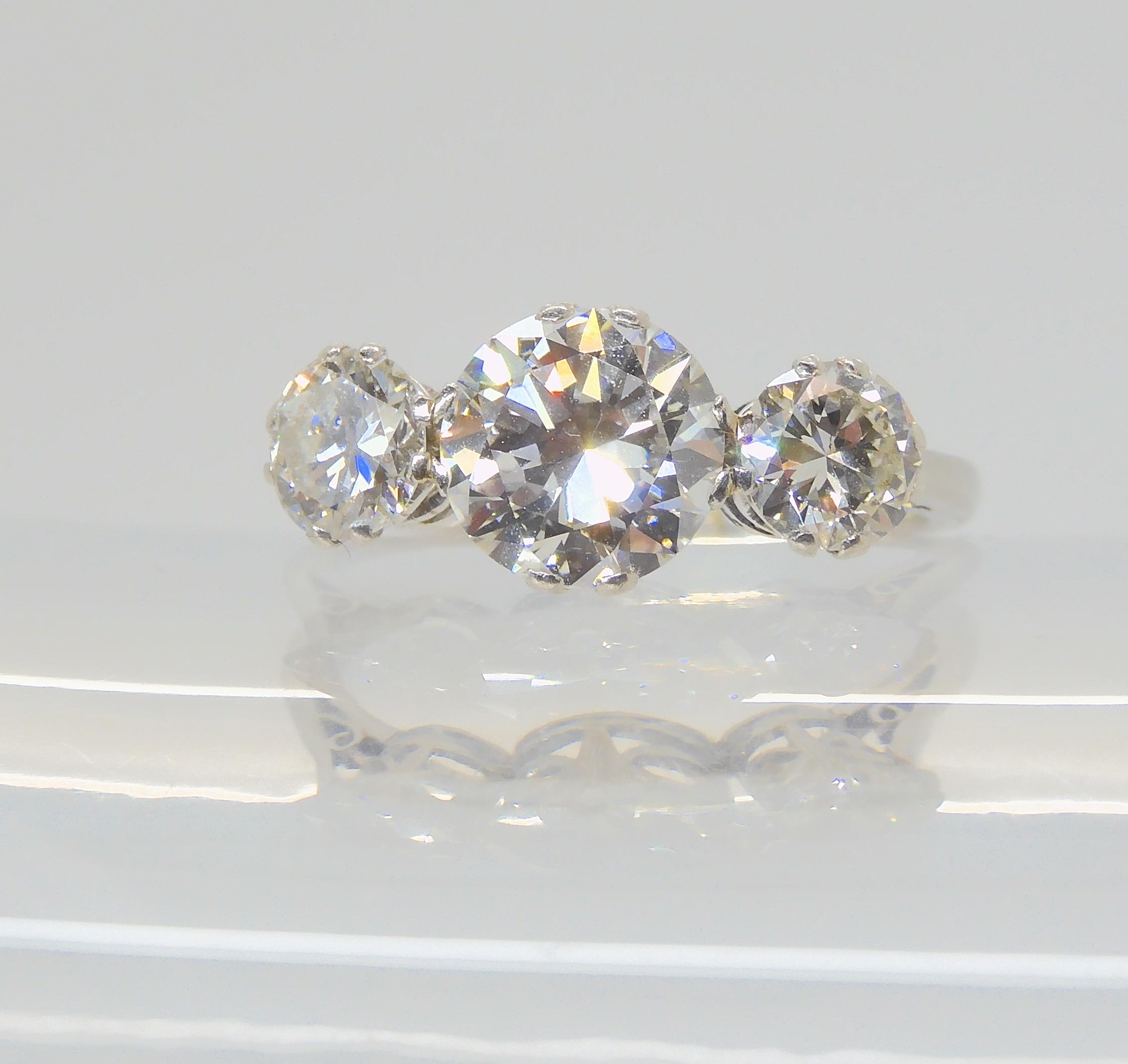 A SUBSTANTIAL DIAMOND THREE STONE RING mounted throughout in platinum, with a really pretty setting. - Image 5 of 8