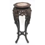 A 19TH CENTURY CHINESE HARDWOOD PLANT PEDESTAL with octagonal top with marble insert over carved