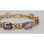 A FANCY LINK AMETHYST BRACELET the box clasp stamped 18k, and set with seven step cut amethysts with