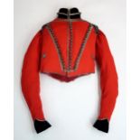 A RARE YEOMANRY CAVALRY TUNIC, CIRCA 1820 The scarlet wool body with black velvet facings to the