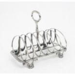 A WILLIAM IV SILVER SIX DIVISION TOAST RACK the divisions double loop shaped, the shaped rectangular