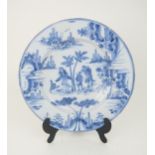 AN 18TH CENTURY DELFT CHARGER possibly north German Hanau, painted in blue and white with figures