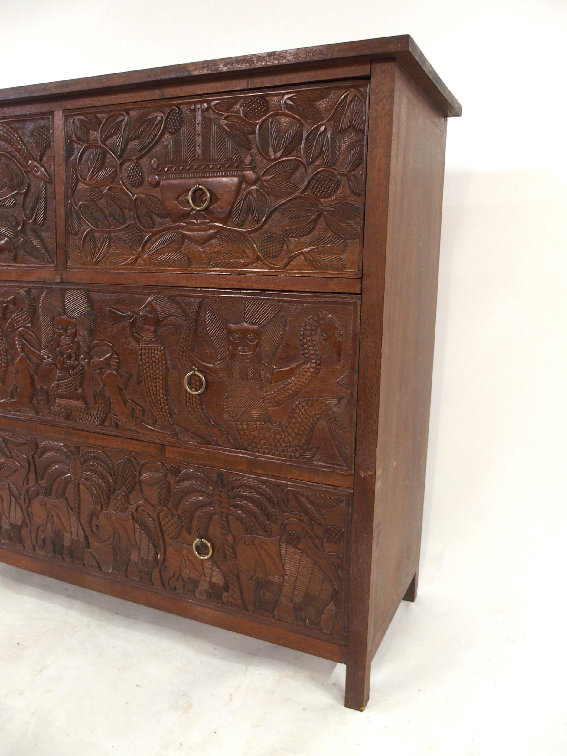 A 20TH CENTURY AFRICAN HARDWOOD TWO OVER TWO CHEST OF DRAWERS  with extensively carved drawer - Image 7 of 7