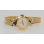 AN 18CT GOLD DIAMOND SET LADIES OMEGA  with cream coloured dial, gold coloured baton numeral and