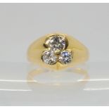 AN 18CT GOLD SHAMROCK DIAMOND RING set with three brilliant cut diamonds with an estimated approx