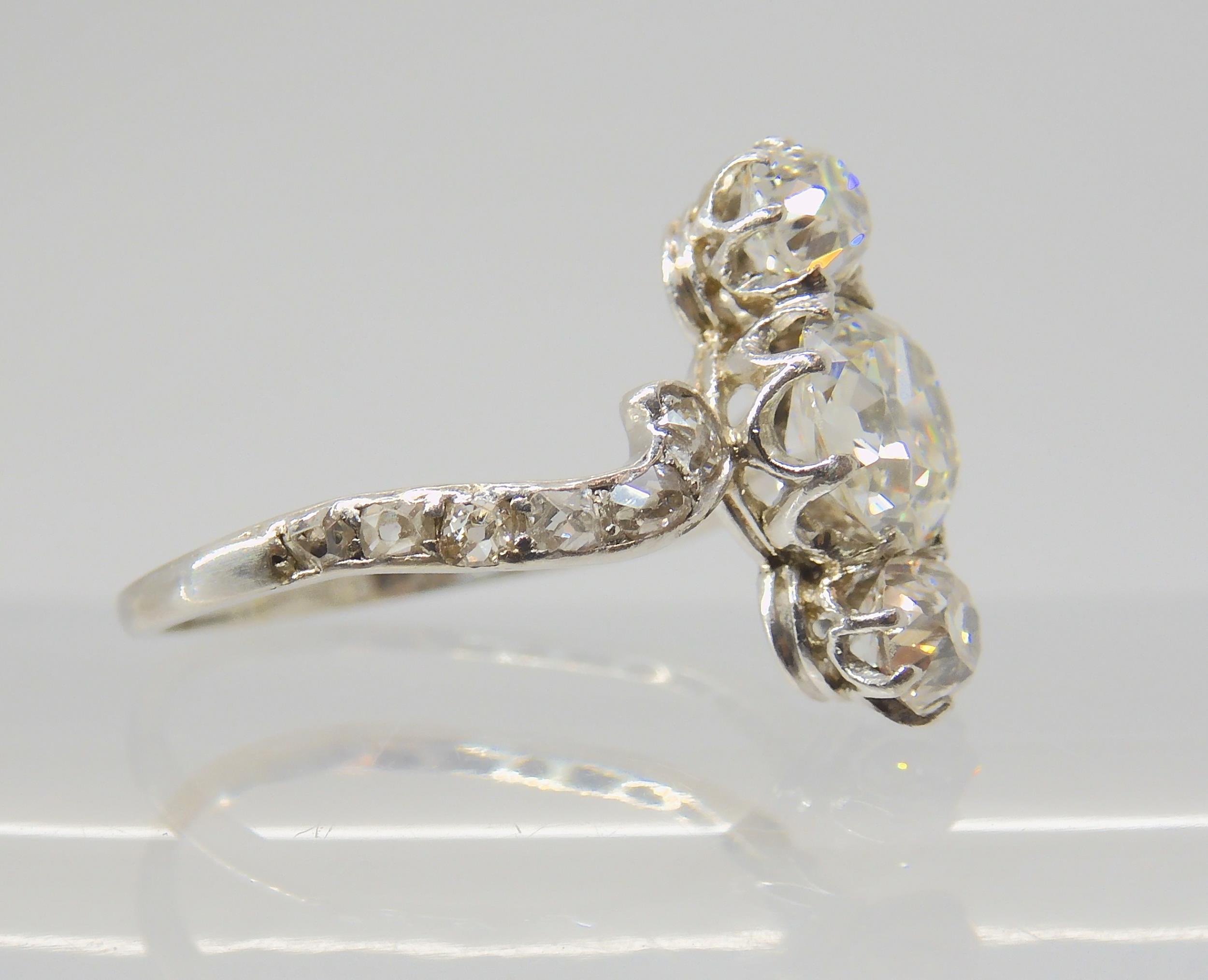 A VINTAGE THREE STONE DIAMOND RING the central old cut is estimated approximately at 0.95cts, with - Image 8 of 12