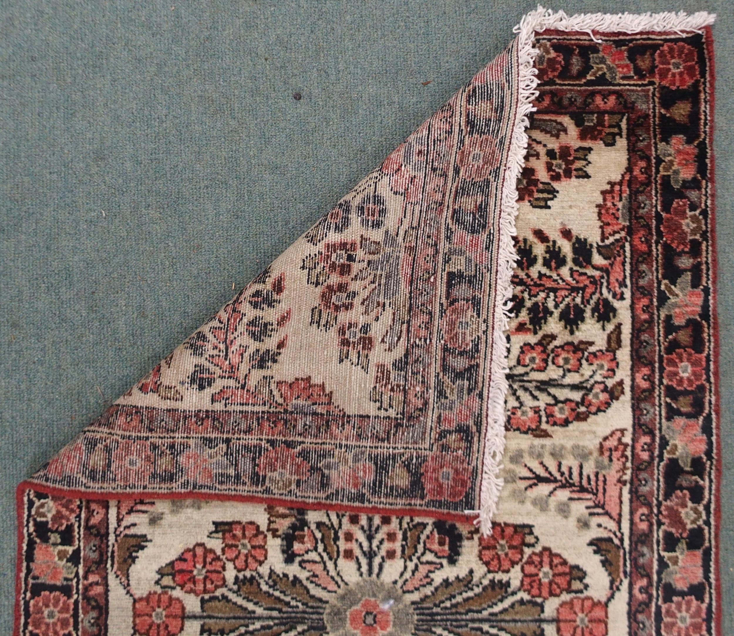 A CREAM GROUND HAMADAN RUNNER with seven floral medallions and dark blue floral border, 459cm long x - Image 6 of 6