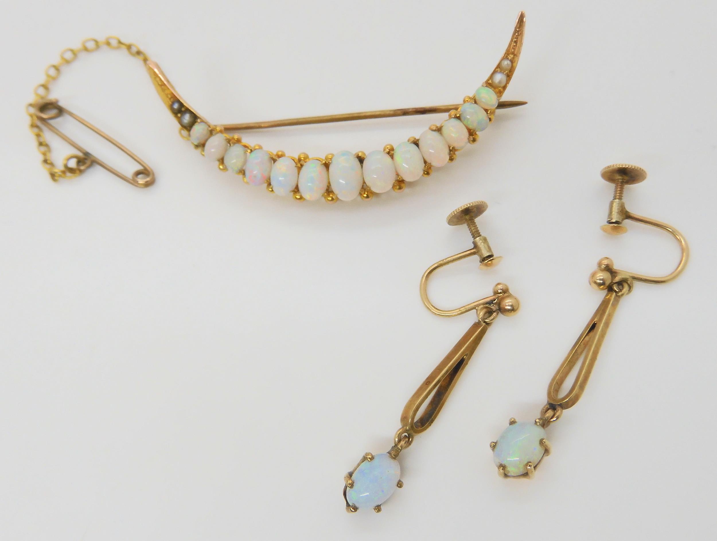 AN OPAL CRESCENT BROOCH & EARRINGS the brooch set with oval cabochon opals, largest approx 6mm x 4mm